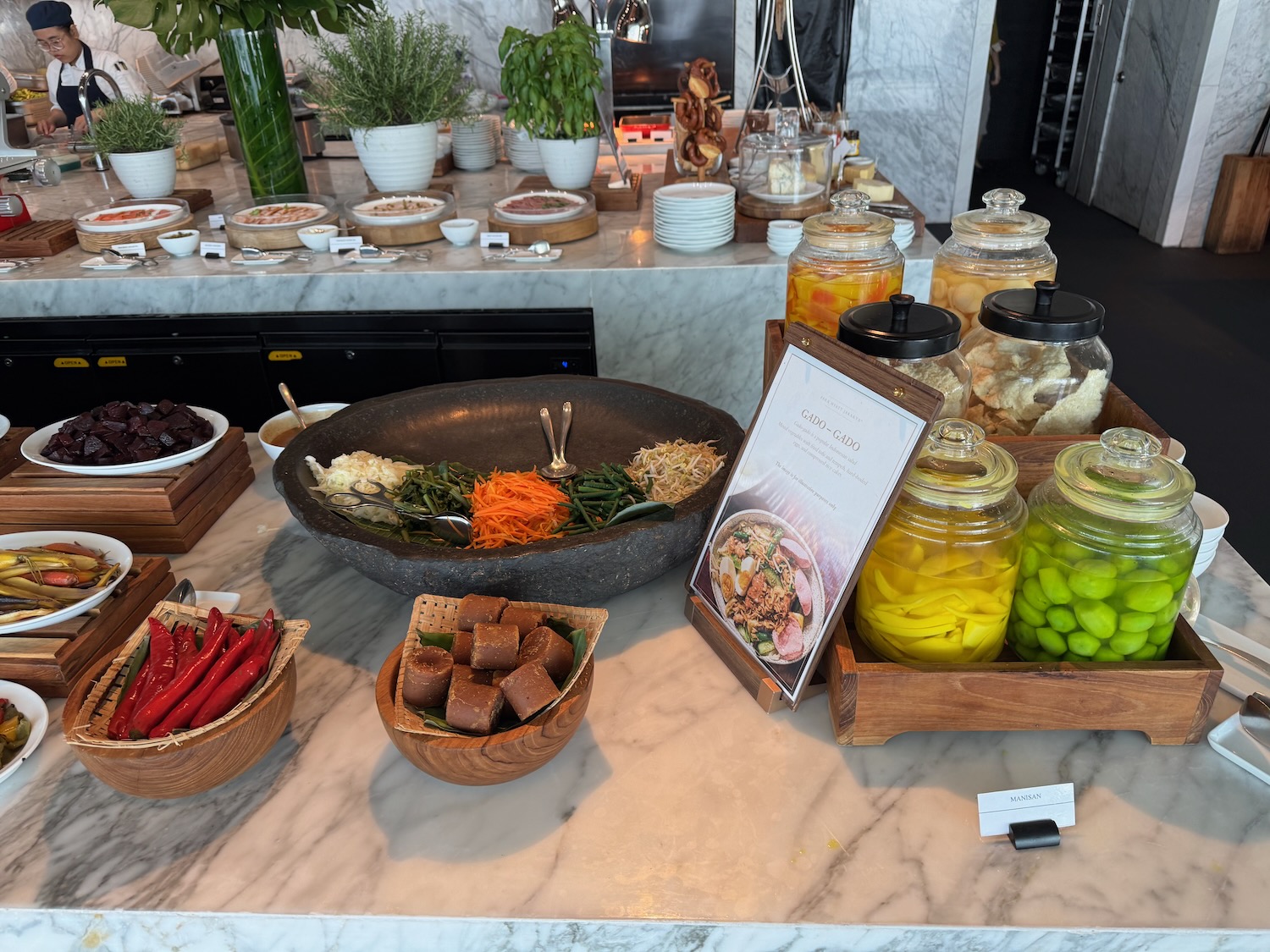a buffet table with food and a sign