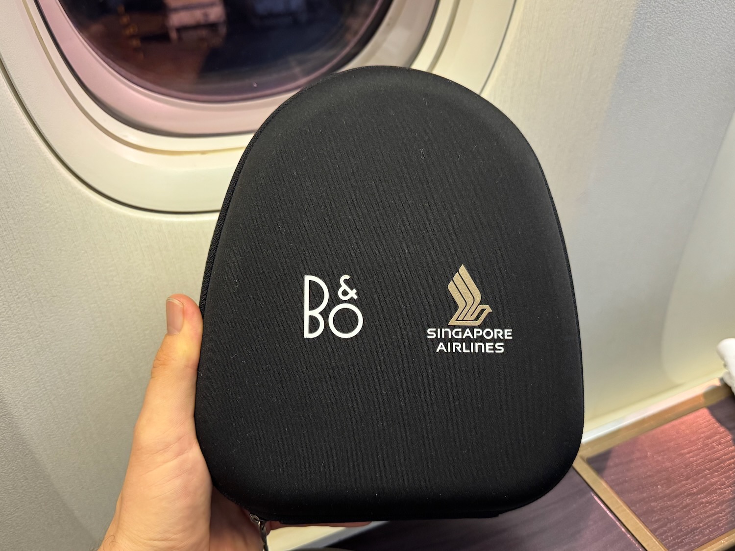a hand holding a black case