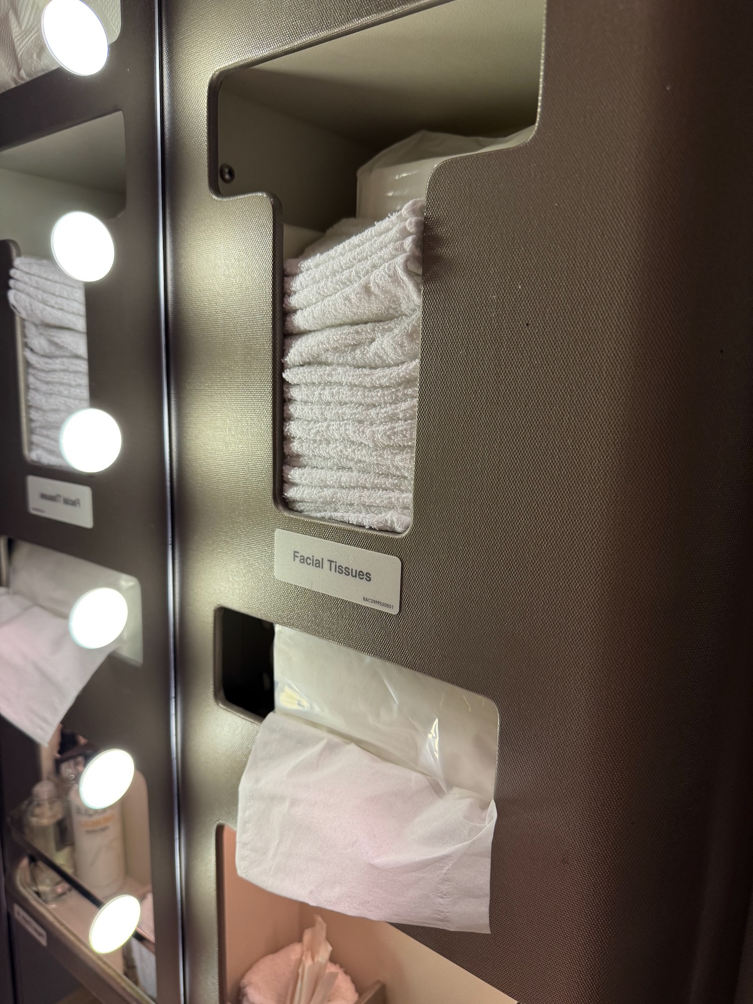 a shelf with towels and a few lights