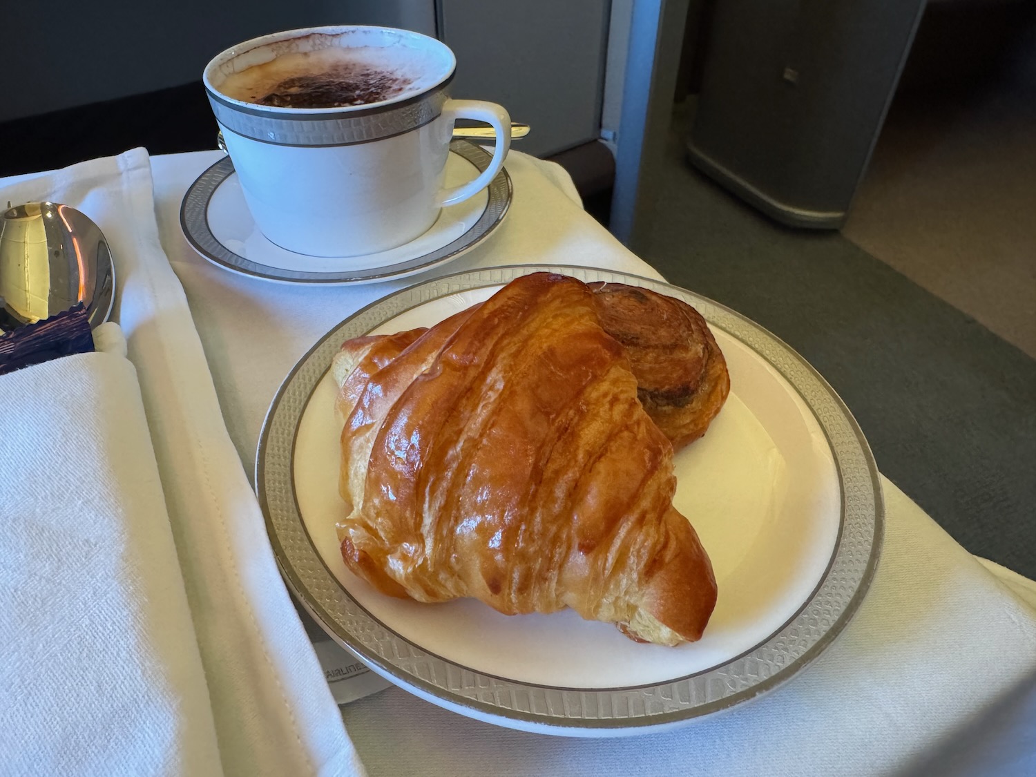 a plate of croissant and a cup of coffee
