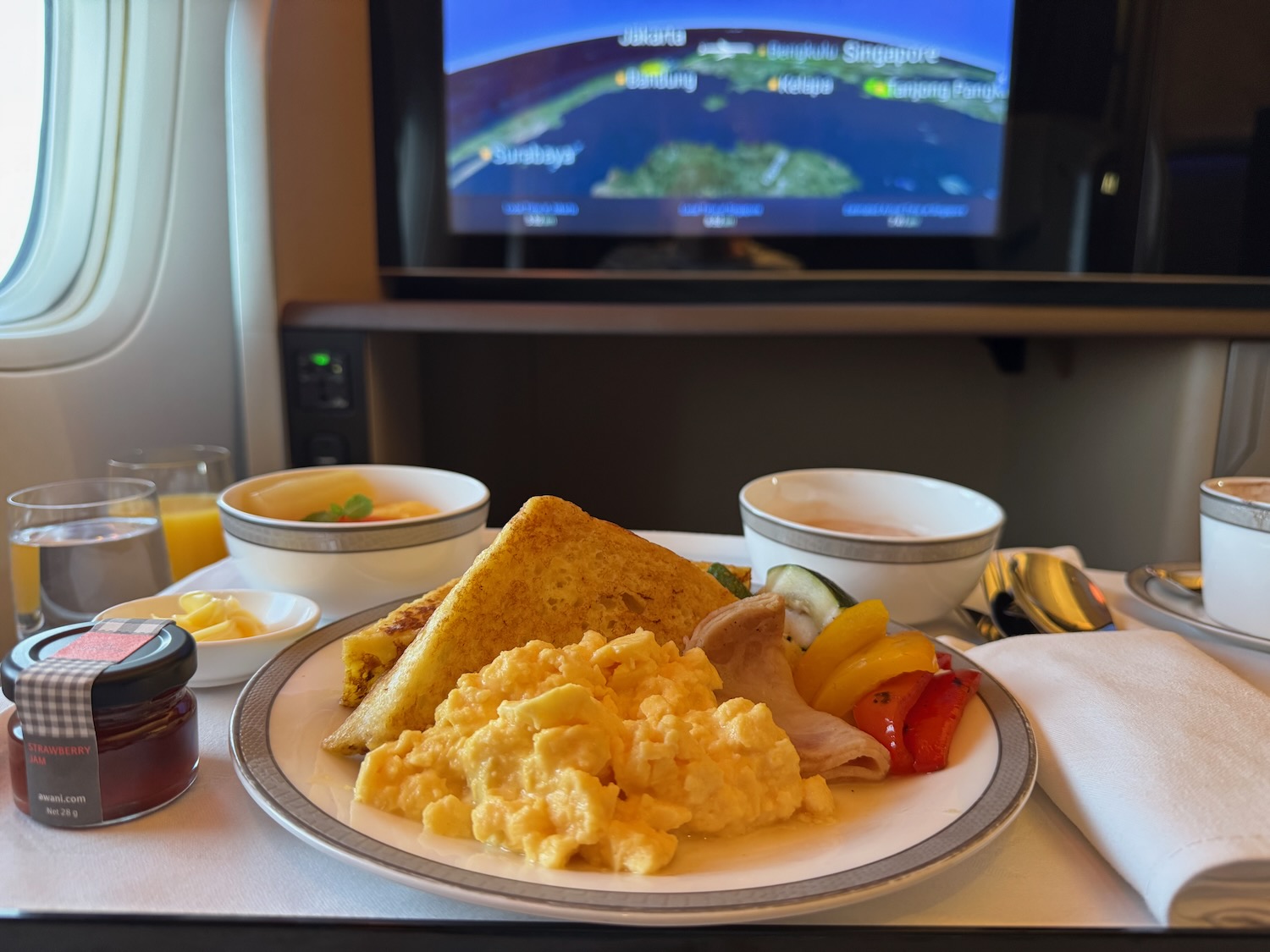 a plate of food on a table with a television in the background