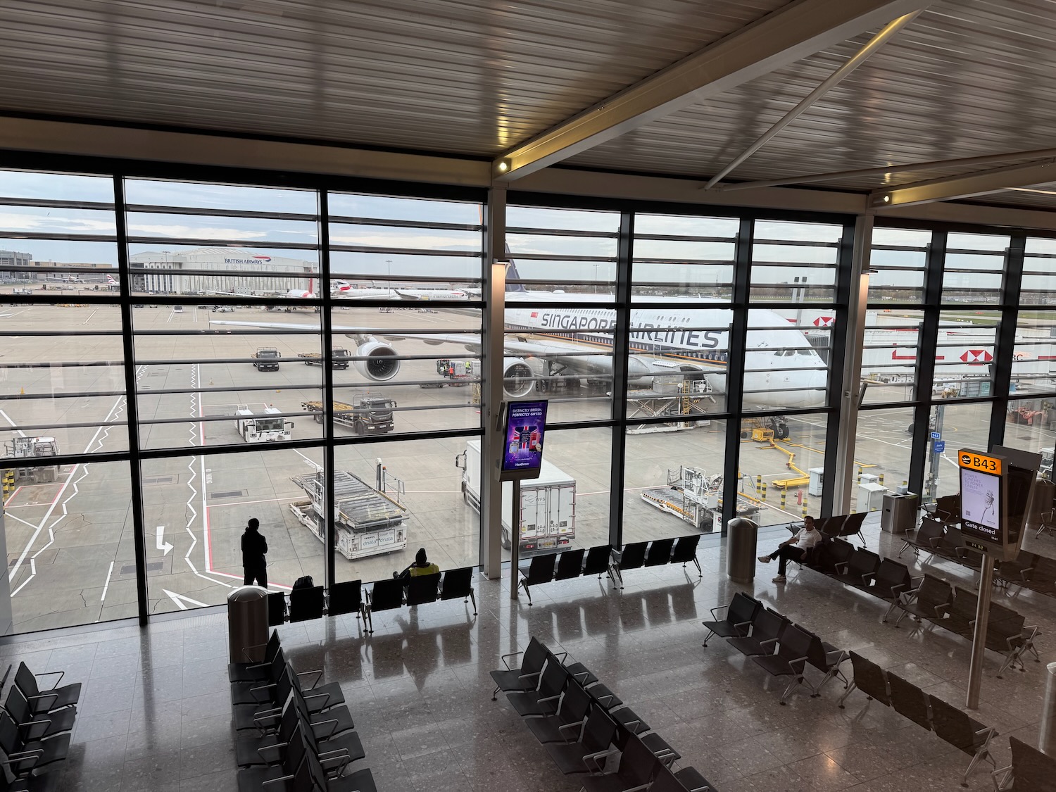 an airport with many windows and chairs