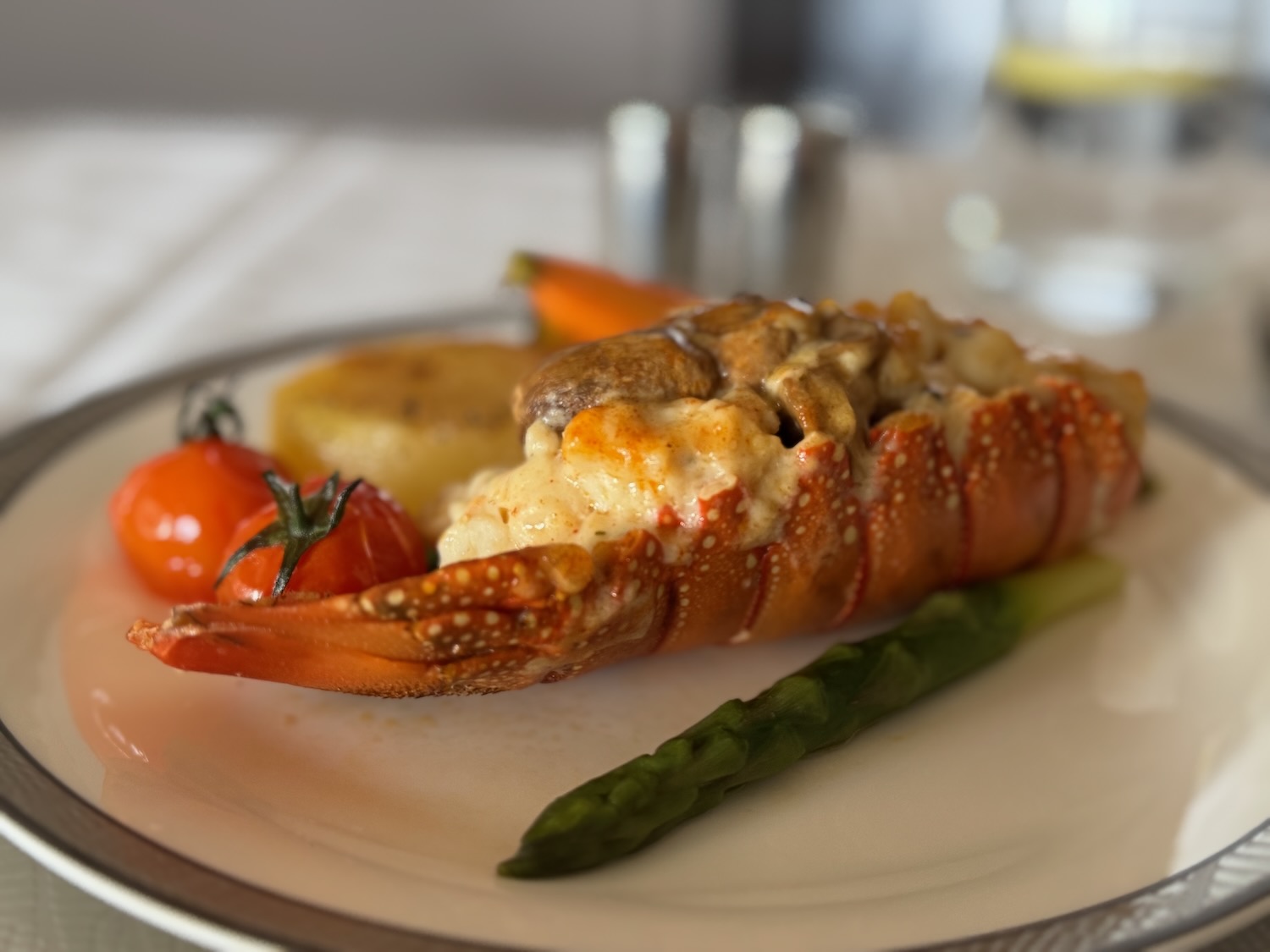 a lobster tail with vegetables on a plate