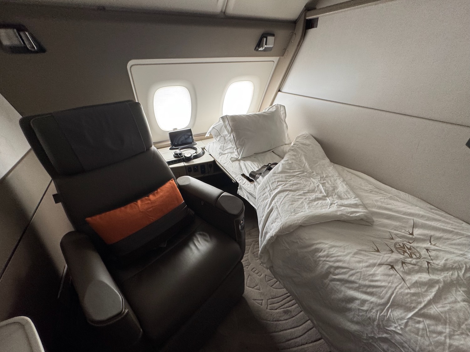 a bed and chair in an airplane
