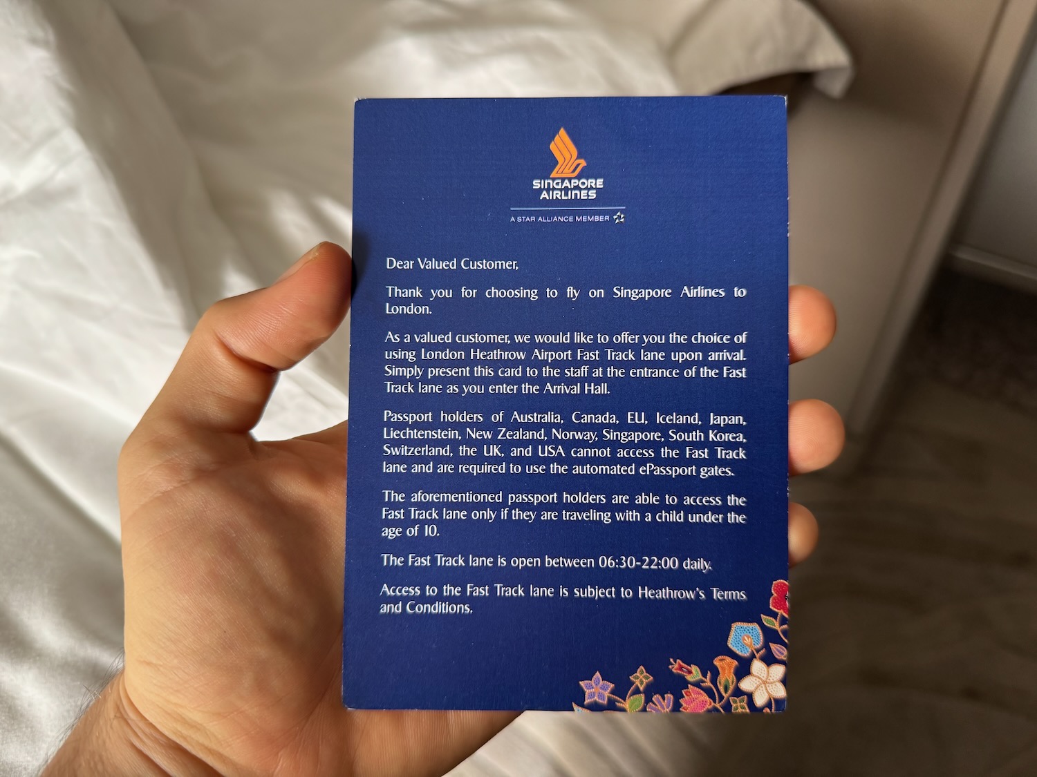 a hand holding a blue card