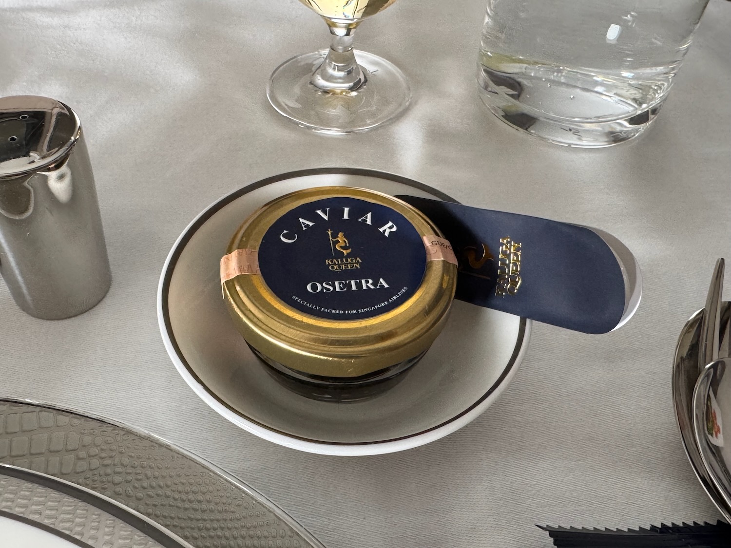 a small round container on a white plate with a blue tag on it