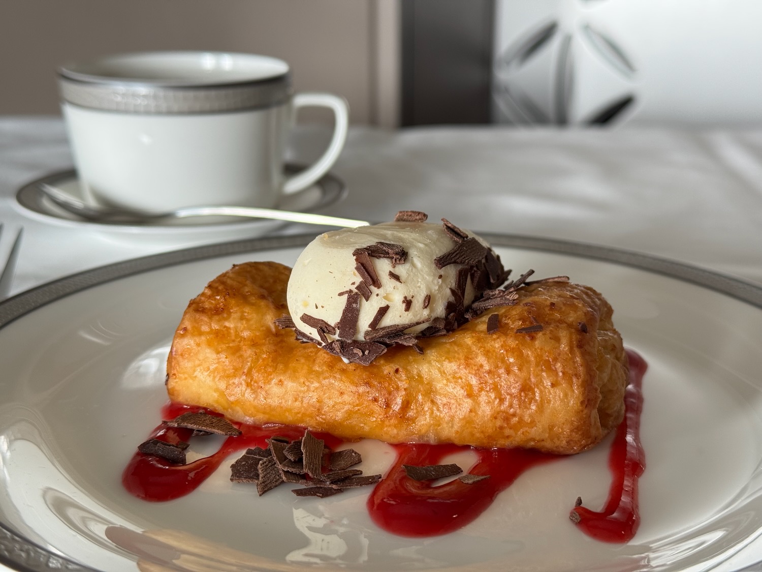 a pastry with ice cream and chocolate shavings on a plate
