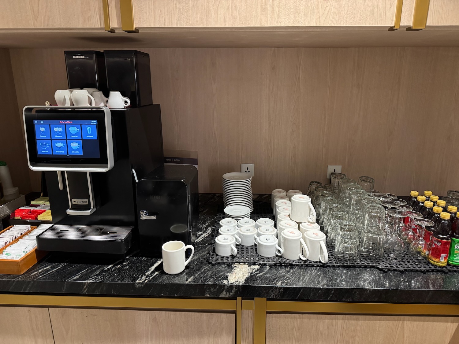 a coffee machine and cups on a counter