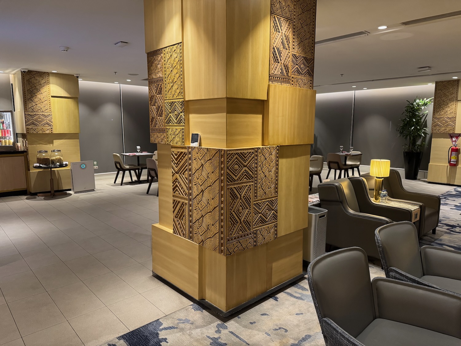 a room with a tall column and chairs