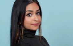 a woman with long hair wearing a black turtleneck