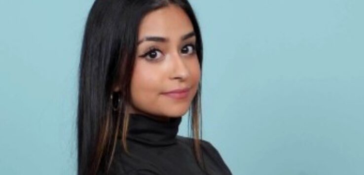 a woman with long hair wearing a black turtleneck